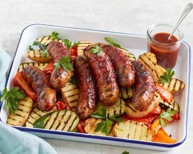 Beef sausages with smoky glaze and grilled vegetables